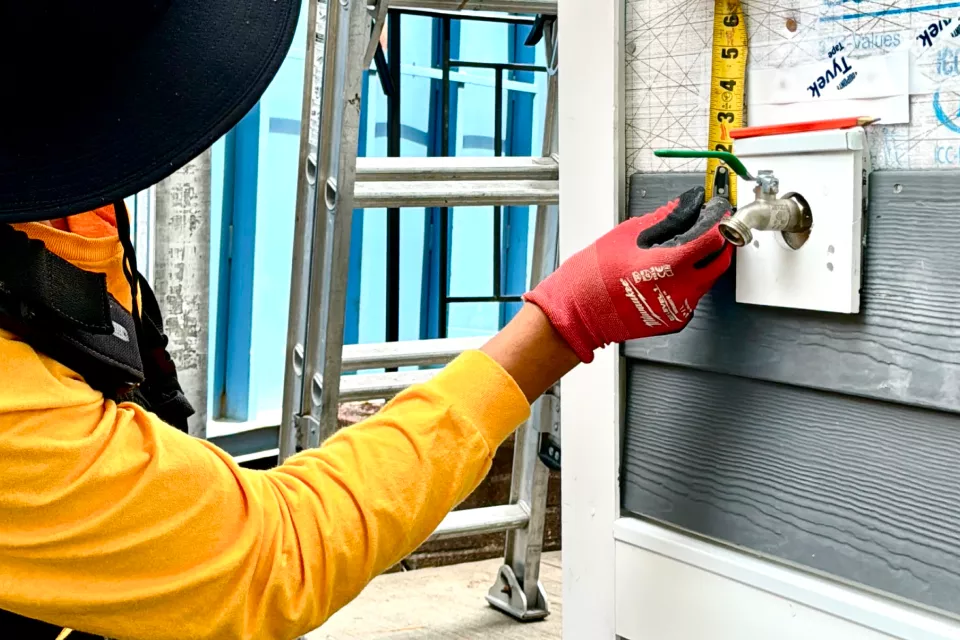 Hand patching one cracked siding panel with basic tools