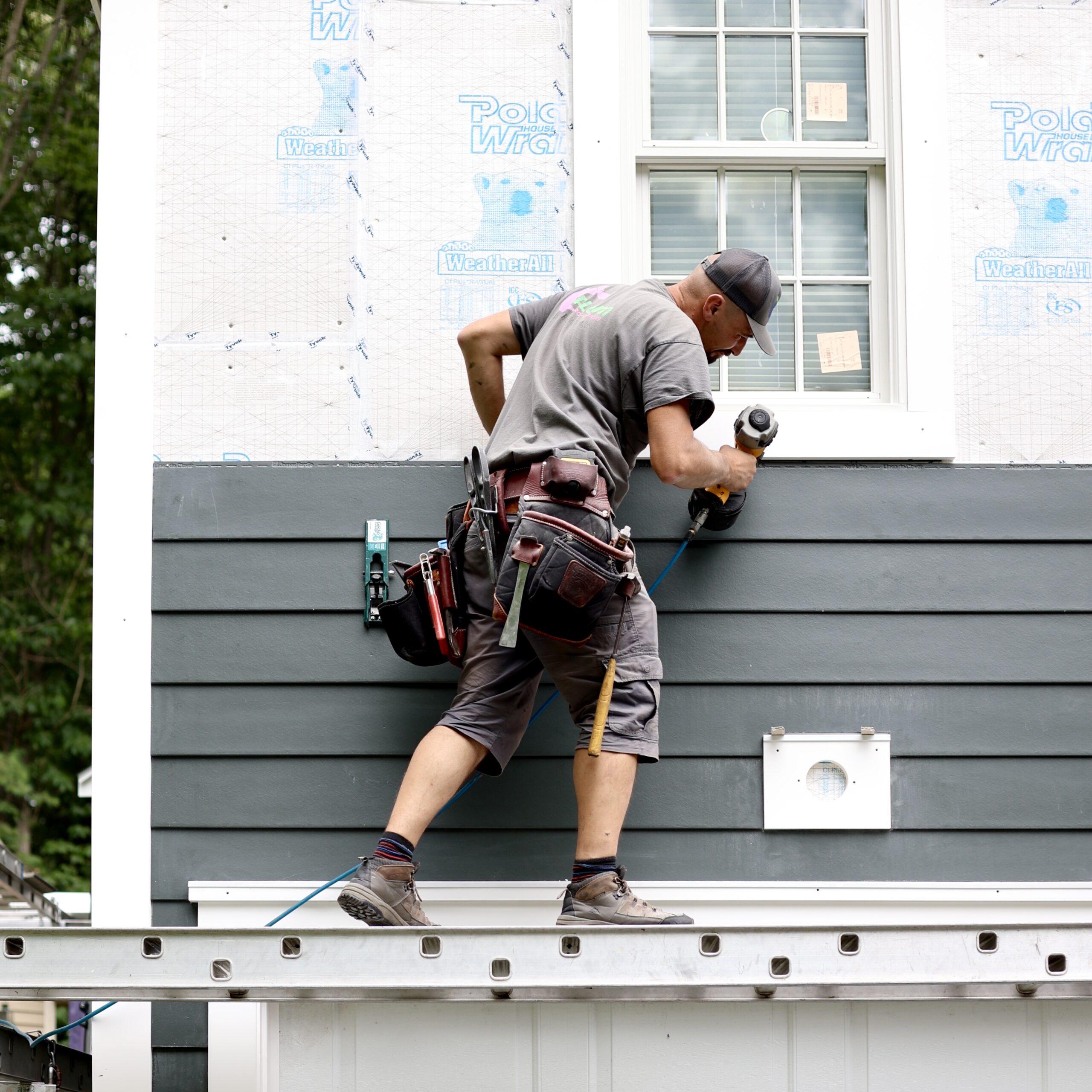Plum ProExteriors installer nailing new lap siding