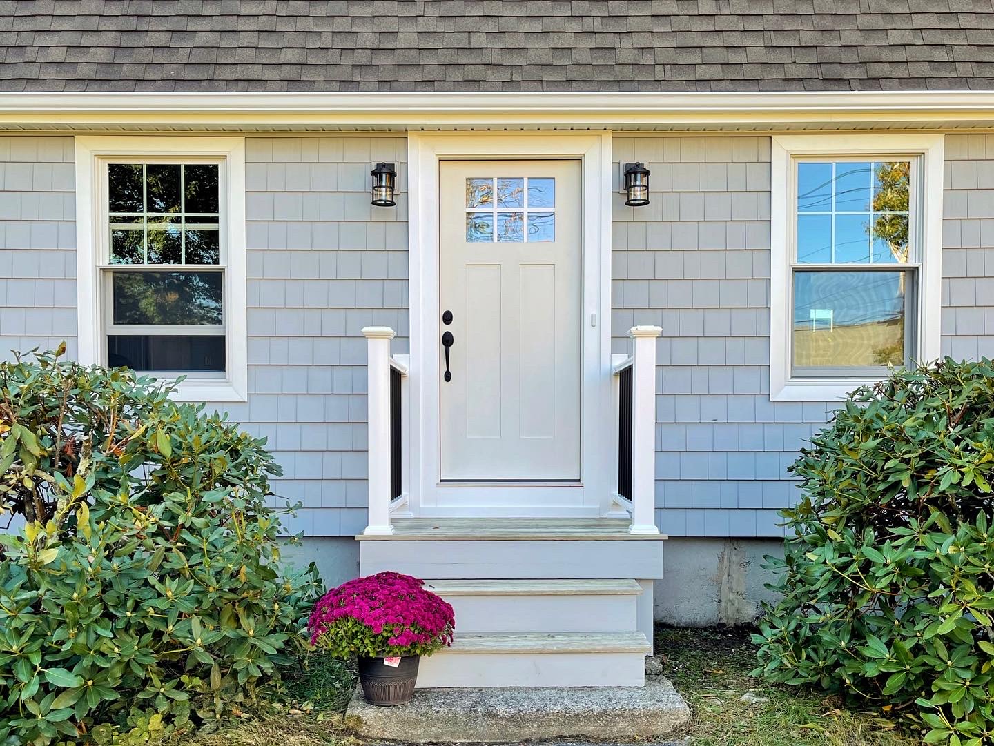 White front door on light blue siding
