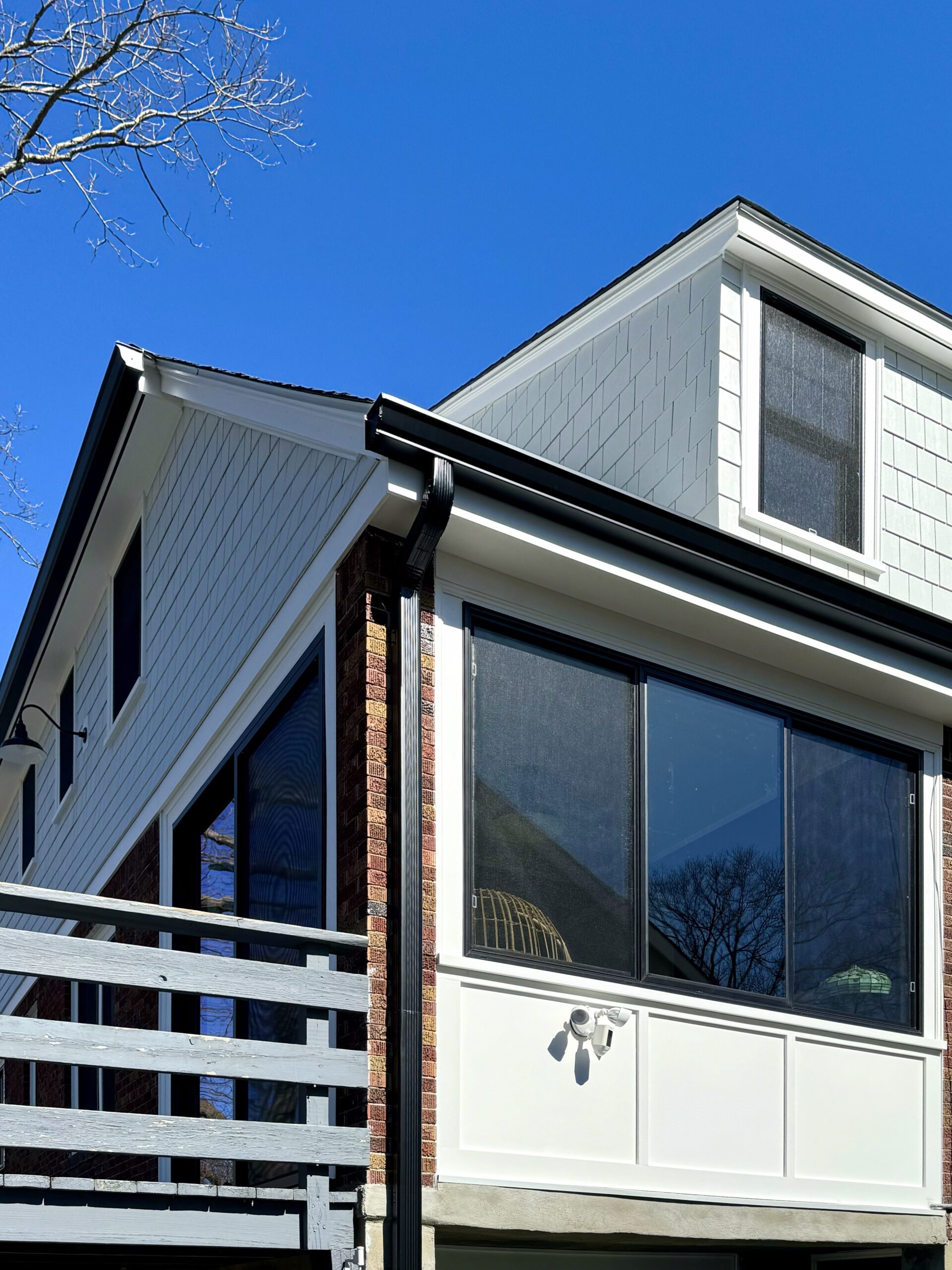 Black gutters and downspouts on a modern home