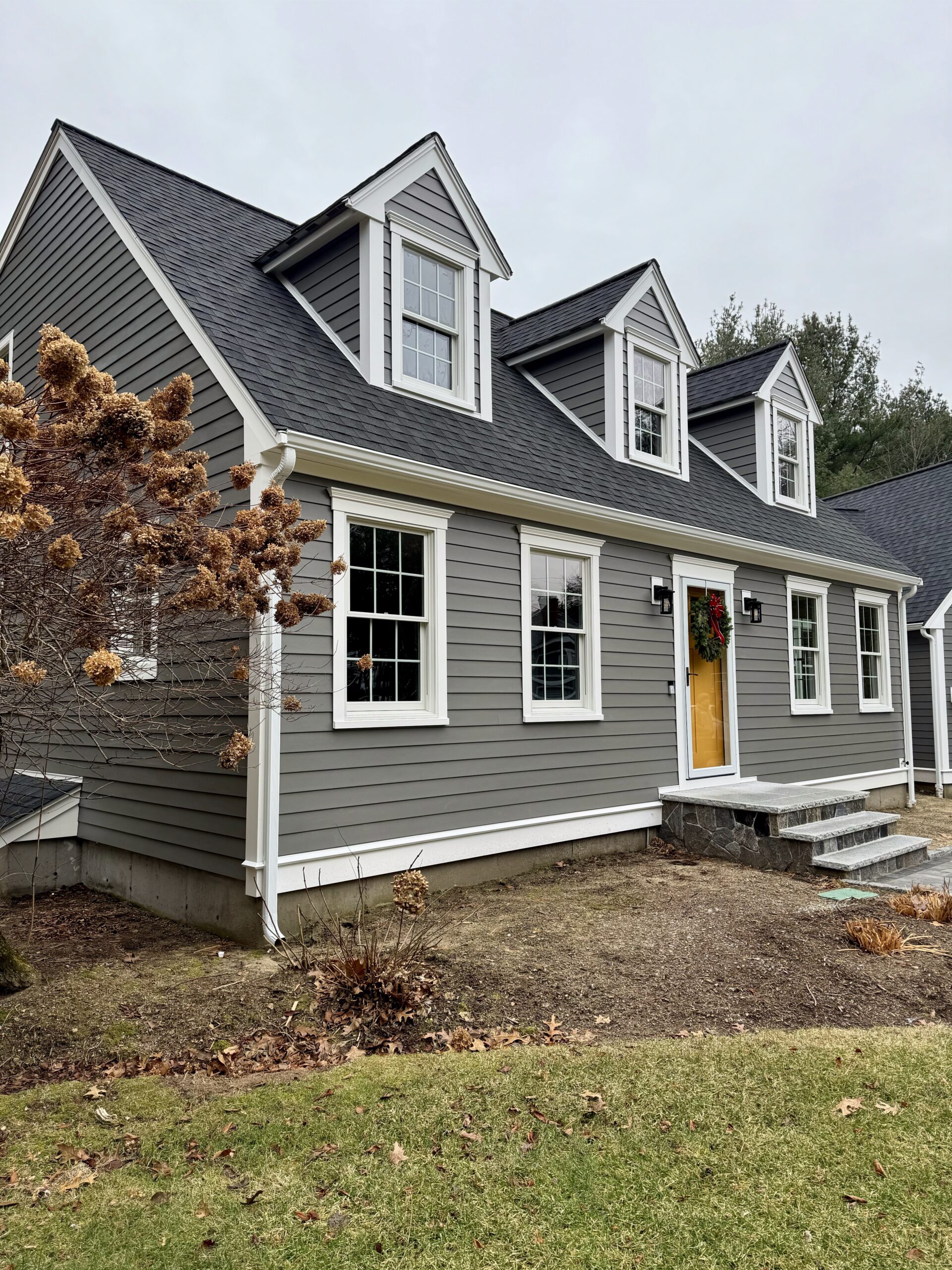 Gutters on a gray cape with dormers