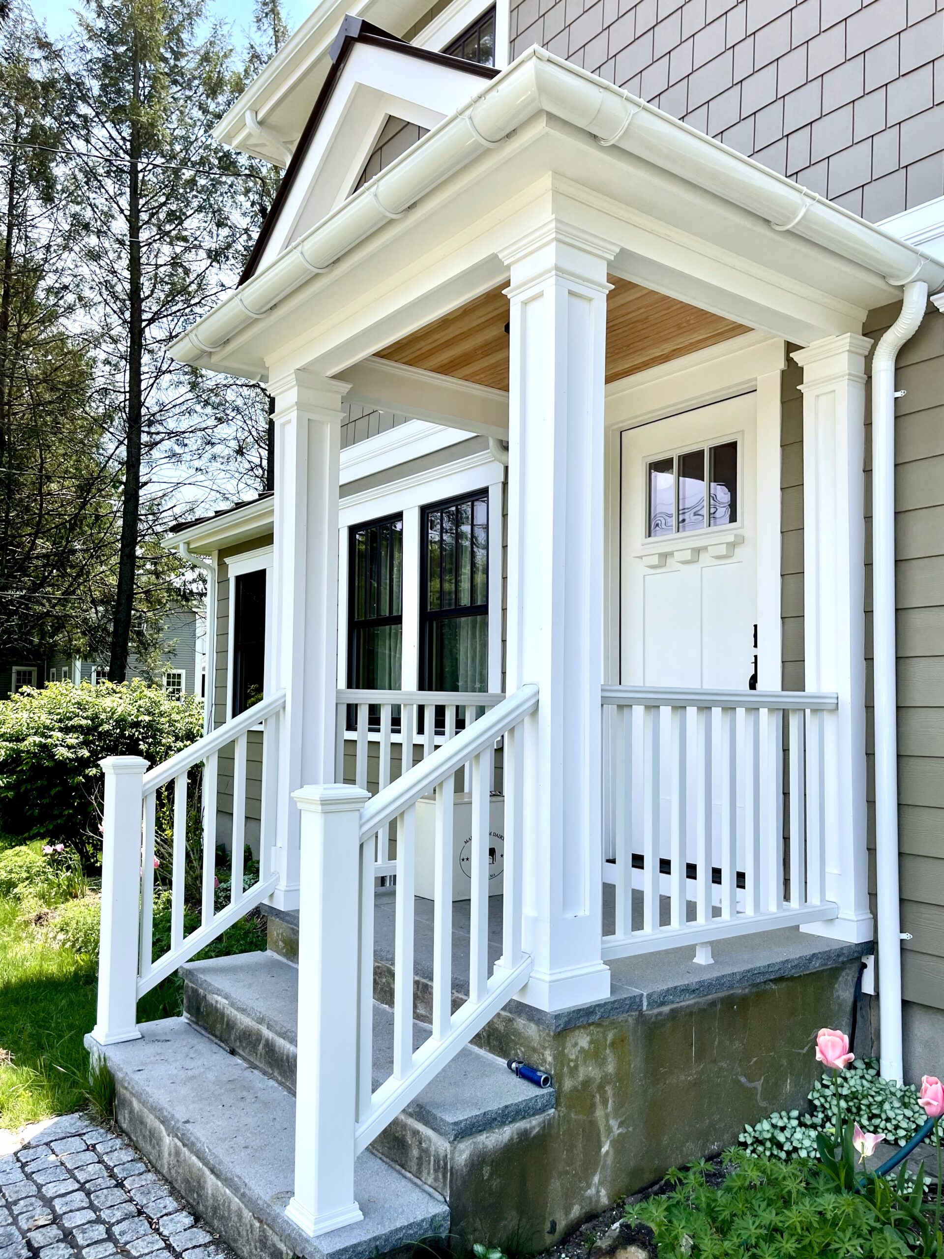 White gutters on a portico entry