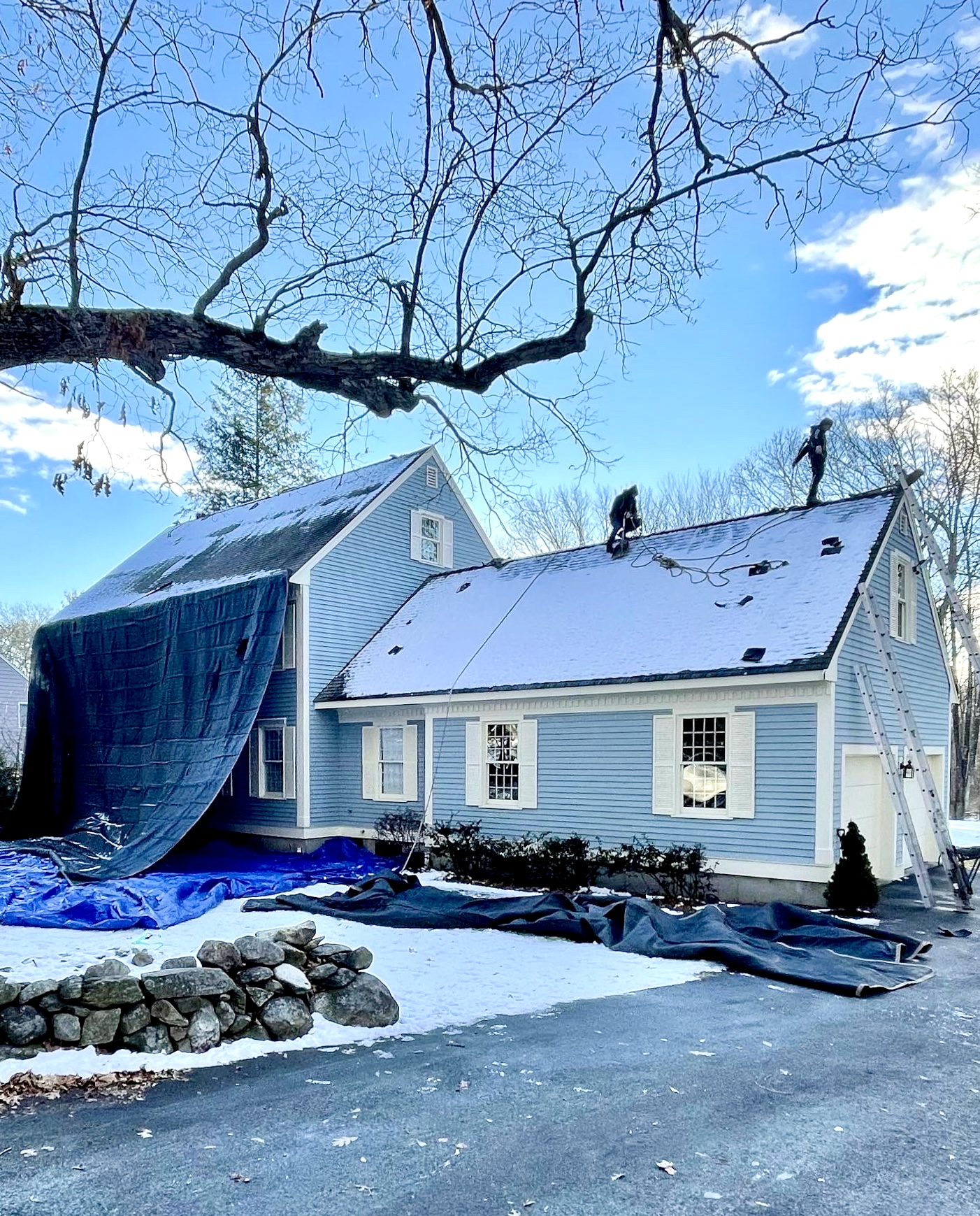 Roofing crew working on a snow-covered roof