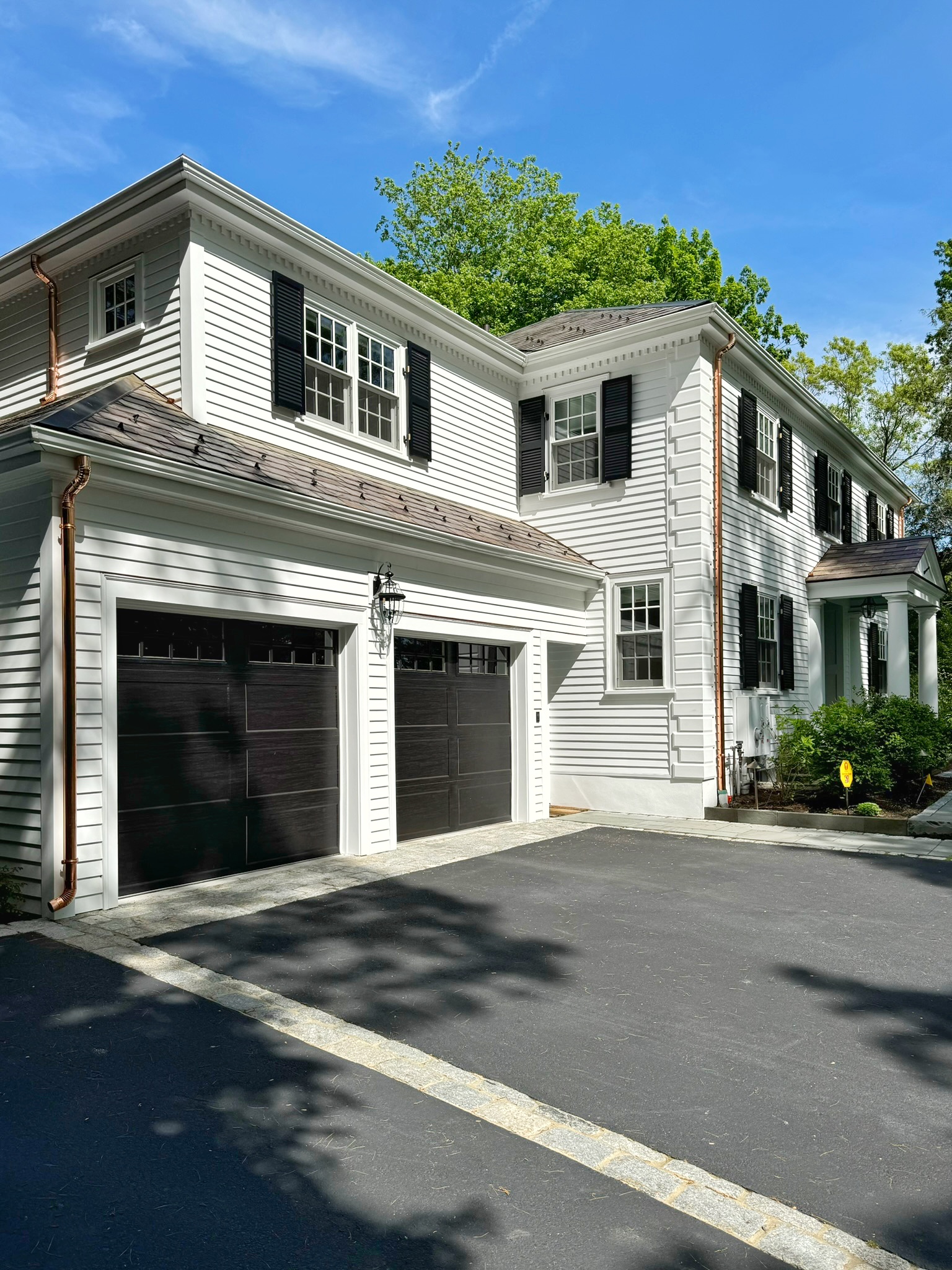 Gutters and copper downspouts above a garage